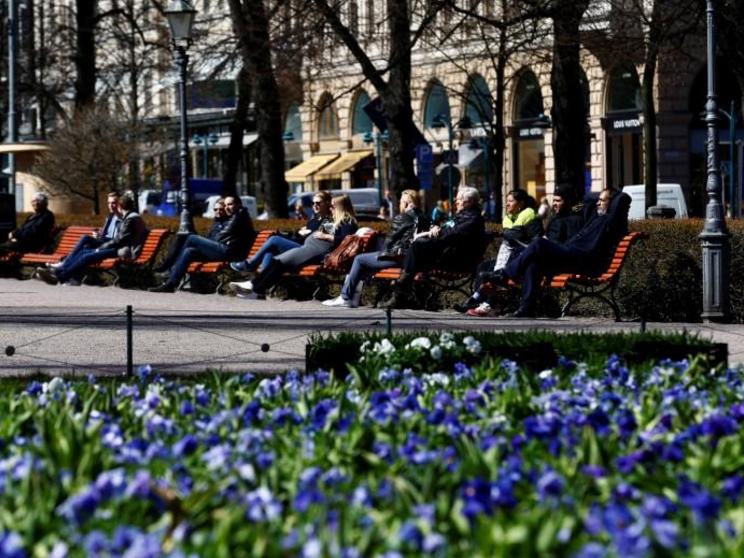 People enjoy a sunnny day at the Esplanade in Helsinki