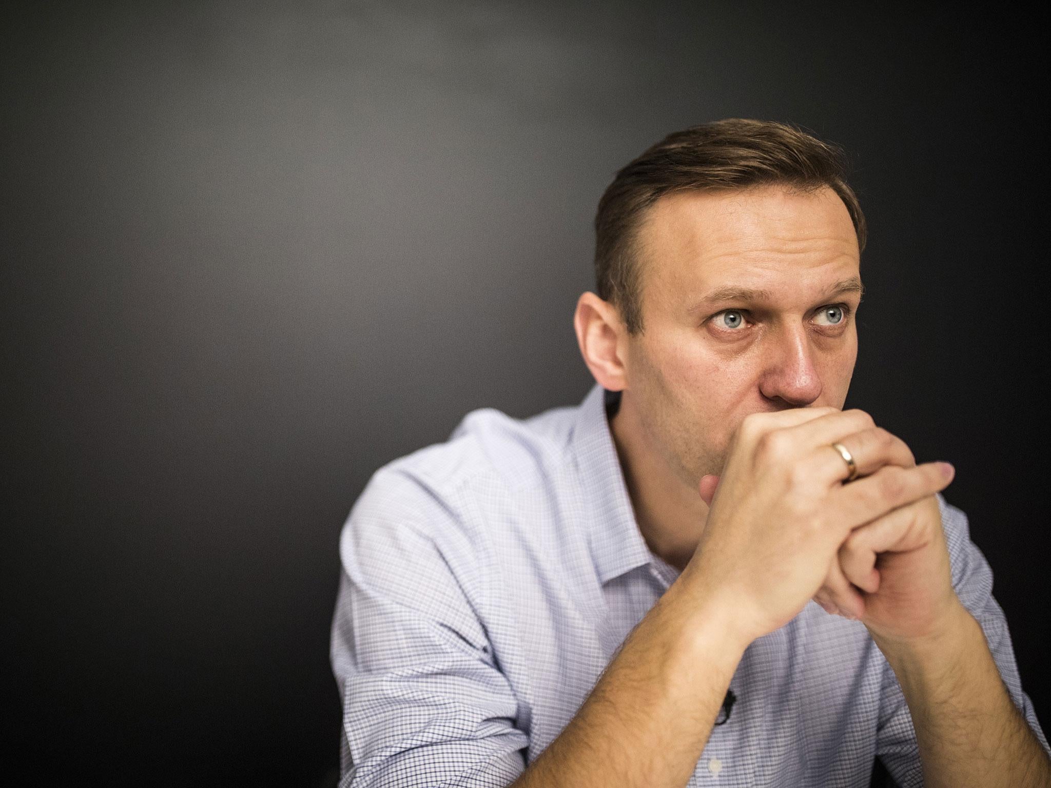 Russian opposition leader Alexei Navalny sits in his office after being released from jail in Moscow on Sunday