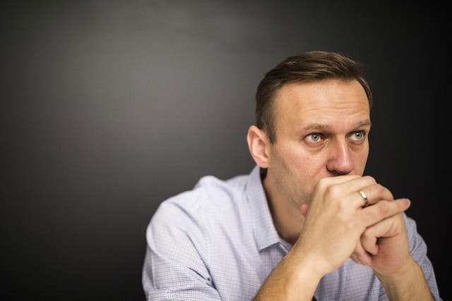 Russian opposition leader Alexei Navalny sits in his office after being released from jail in Moscow on Sunday