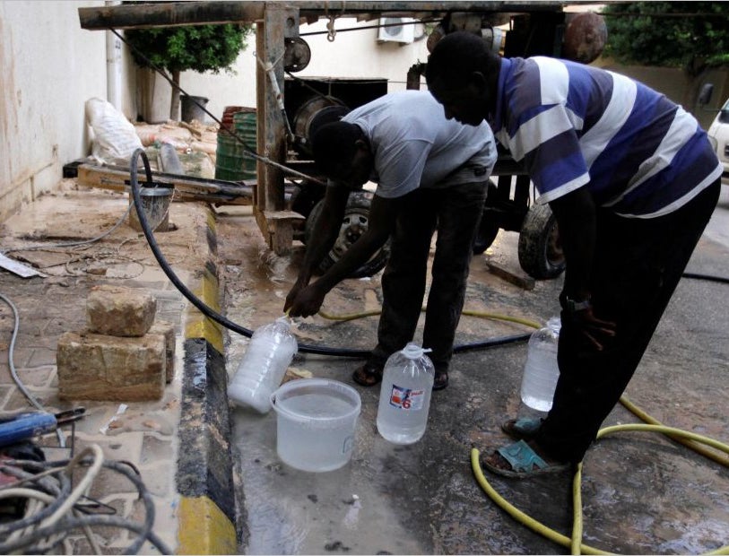 Men fill bottles with water in Tripoli, Libya as taps run dry