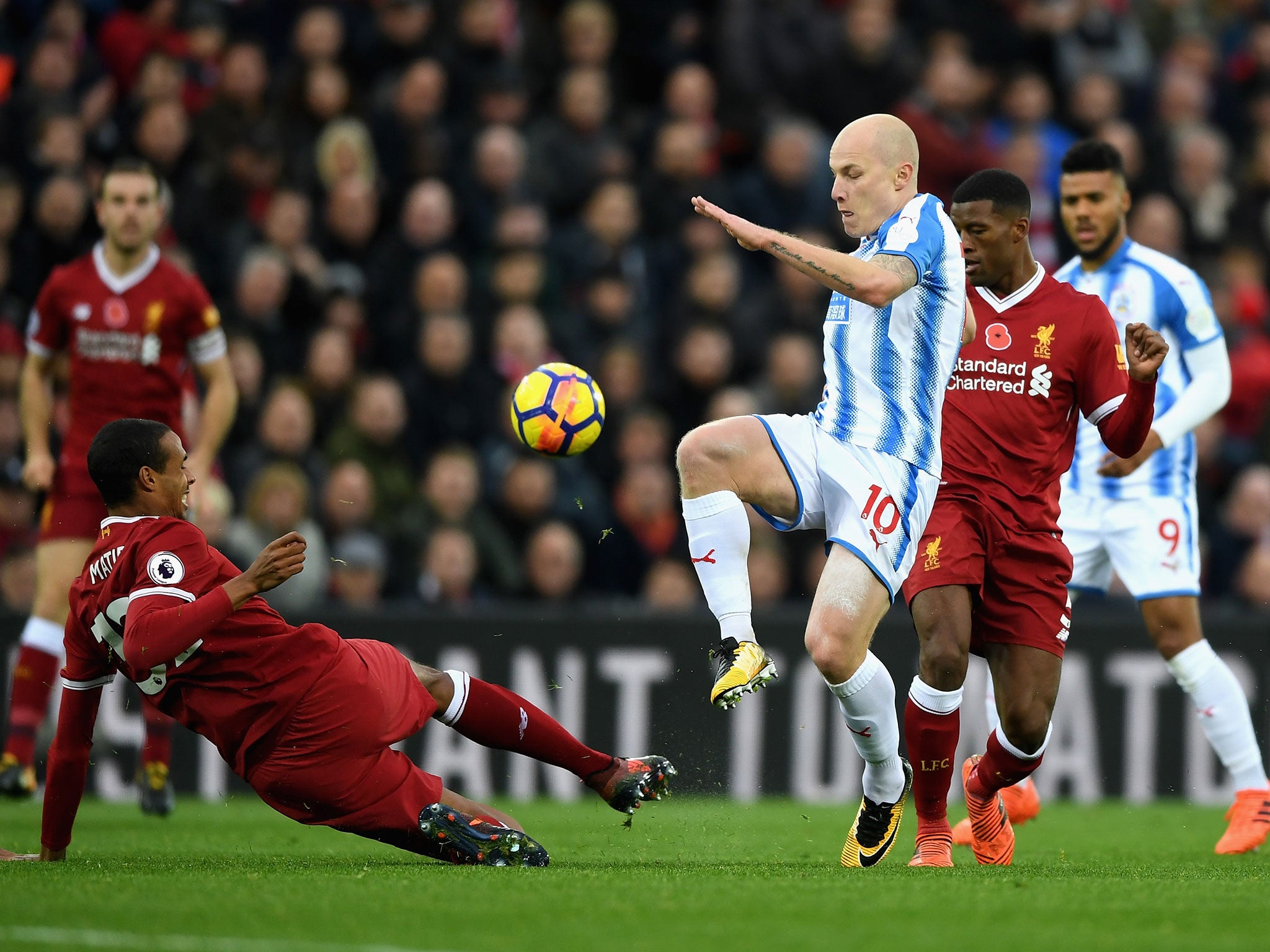 Joel Matip puts in a challenge in on Aaron Mooy