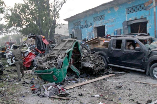 Emergency services rush at the scene of a car bomb attack in Mogadishu; gunfire was also reportedly heard inside a hotel near the presidential palace