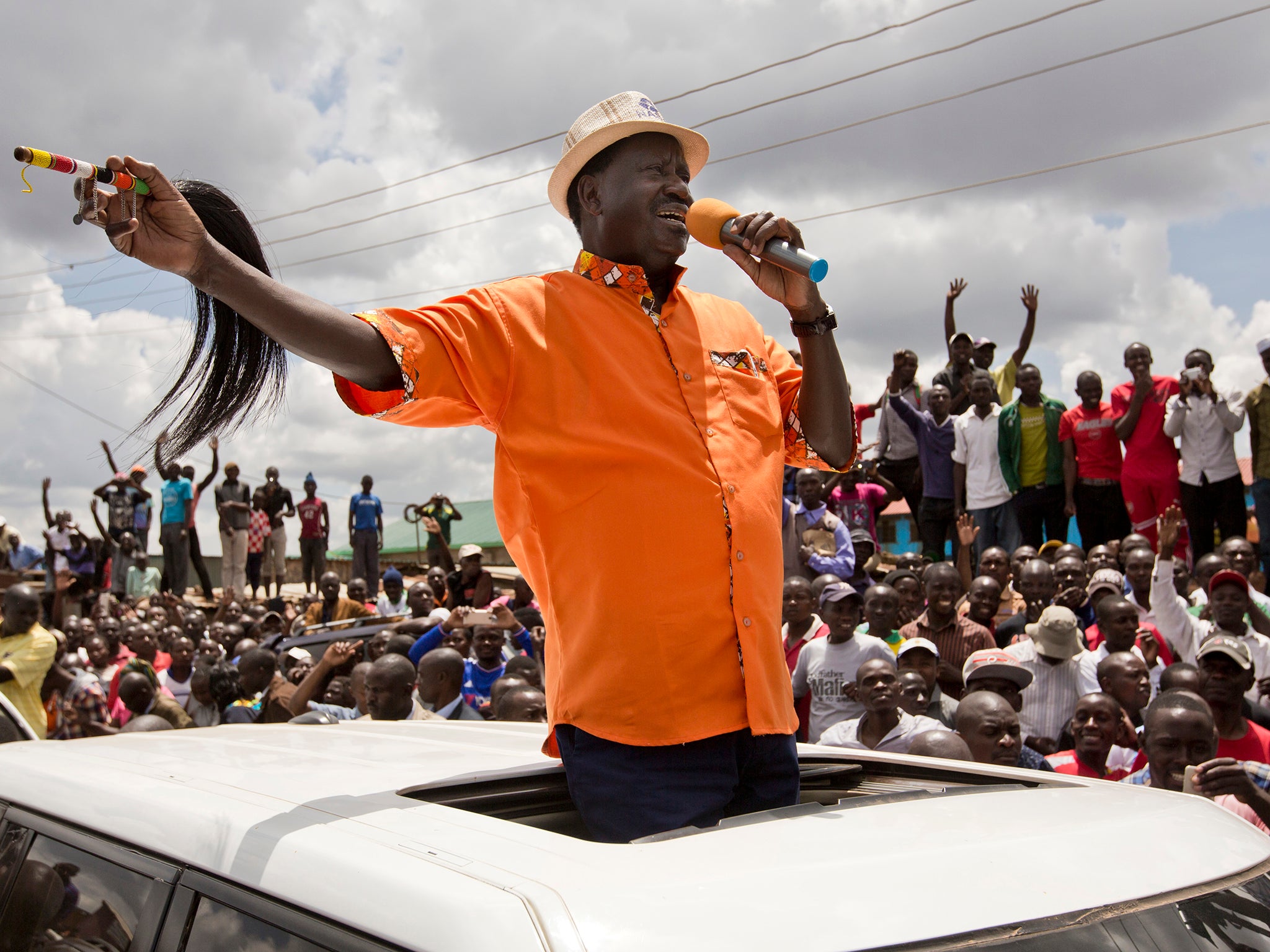 Opposition leader Raila Odinga greets his supporters after attending a church service in the slum of Kawangware in Nairobi, Kenya