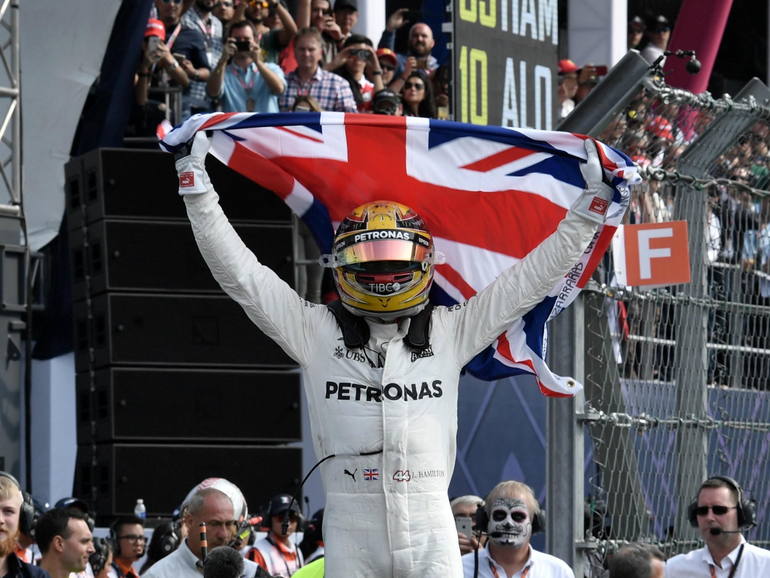 Lewis Hamilton celebrates winning a fourth F1 world championship
