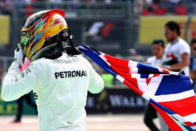 Lewis Hamilton celebrates winning the Formula One world championship for a fourth time