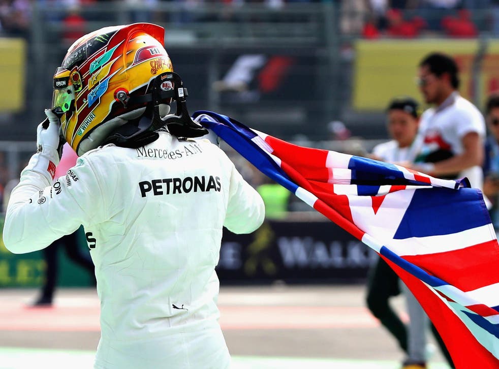 Lewis Hamilton celebrates winning the Formula One world championship for a fourth time