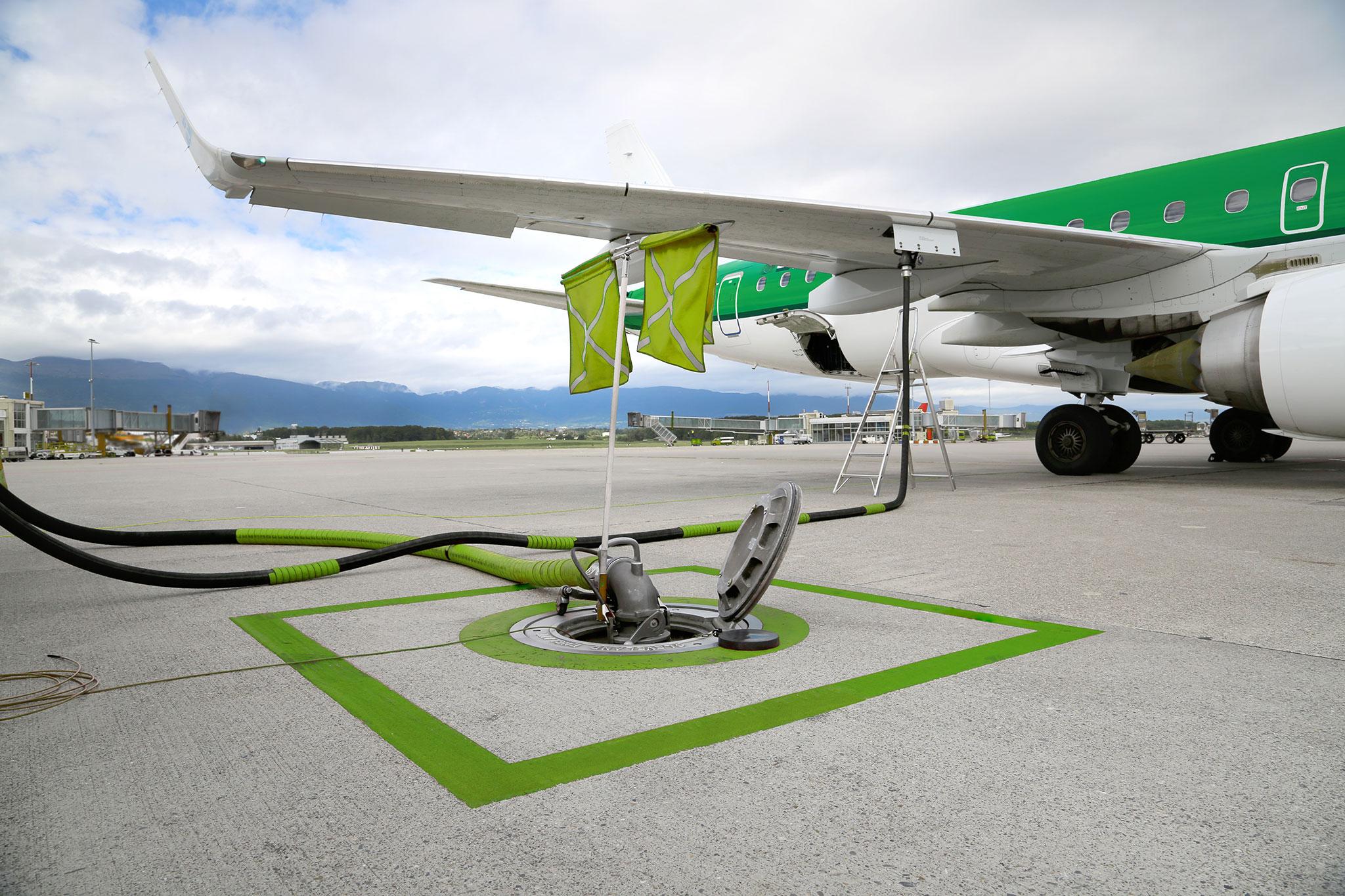 A plane fills up with a blend of renewable diesel and traditional jet fuel at Geneva Airport