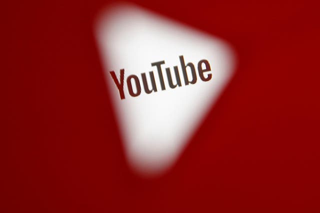 A 3D-printed YouTube icon is seen in front of a displayed YouTube logo in this illustration taken October 25, 2017