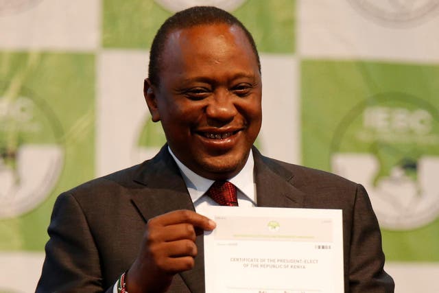 Incumbent President Uhuru Kenyatta holds the certificate of President-Elect of the Republic of Kenya after he was announced winner of the repeat presidential election at the IEBC National Tallying centre in Nairobi