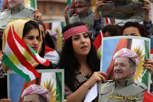 Students of the Salahaddin University hold posters of Iraqi Kurdish leader Massud Barzani during a protest in his support in Irbil, the capital of autonomous Iraqi Kurdistan