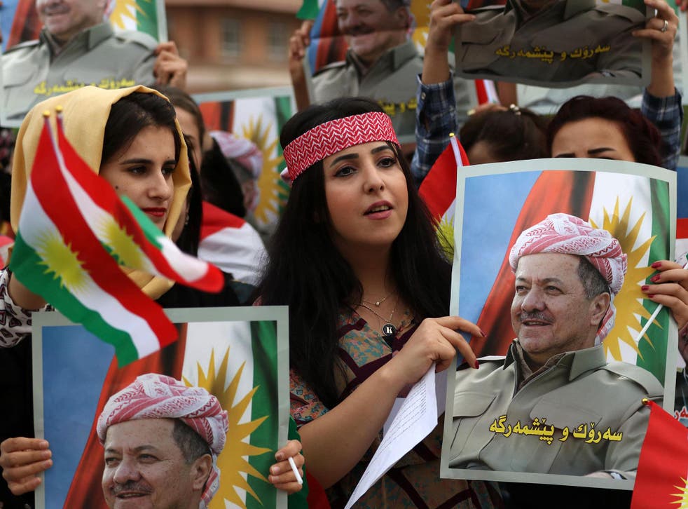 Students of the Salahaddin University hold posters of Iraqi Kurdish leader Massud Barzani during a protest in his support in Irbil, the capital of autonomous Iraqi Kurdistan