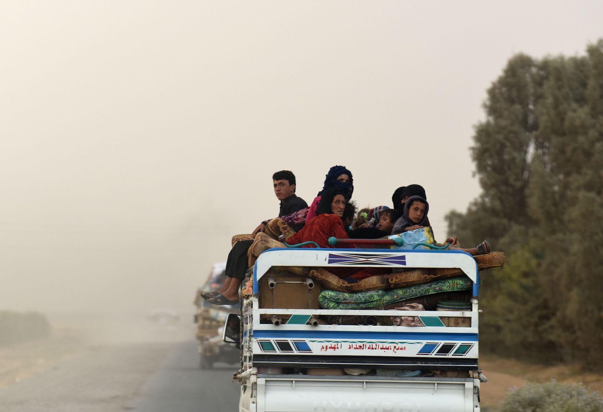 Displaced Syrians from Deir Ezzor head to refugee camps on the outskirts of Raqa. Climate change has been partly blamed for the fighting and displacement in Syria