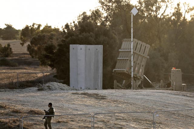 An Israeli soldier stands guard next to Israel's Iron Dome defence system, close to the border with the Gaza Strip near Kibbutz Kissufim in southern Israel, on 30 October 2017