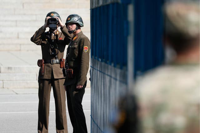 North Korean soldiers look at the South Korean side while US Defense Secretary Jim Mattis the Demilitarized Zone (DMZ) on 27 October 2017 in Panmunjom, South Korea.