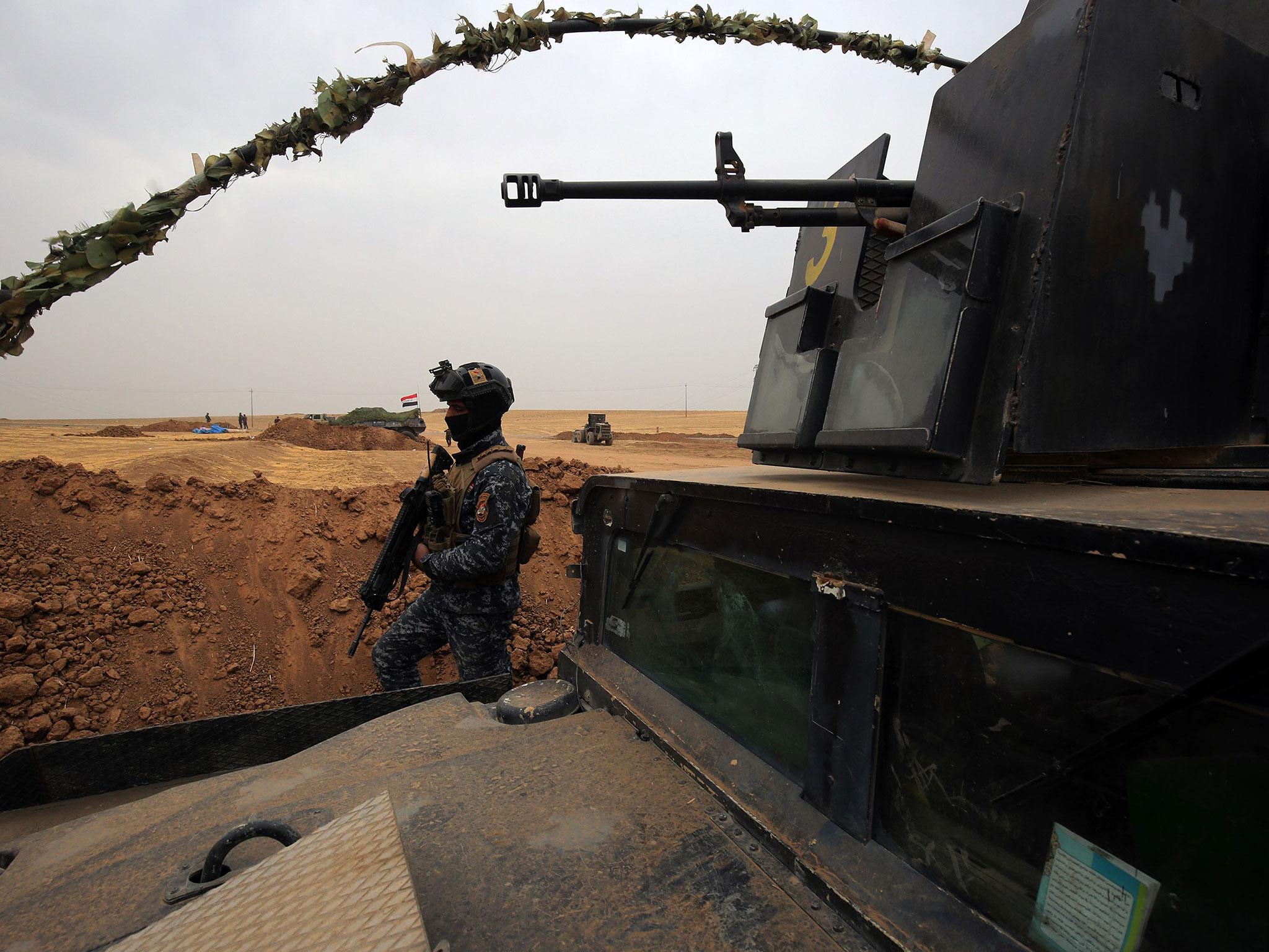 Iraqi forces gather at their camp on the front line, near the borders with Syria and Turkey