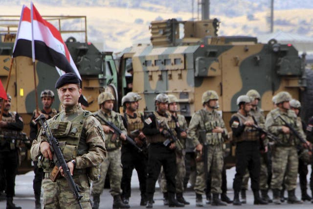 Turkish and Iraqi troops participate in a ceremony at the Habur-Ibrahim Khalil border crossing