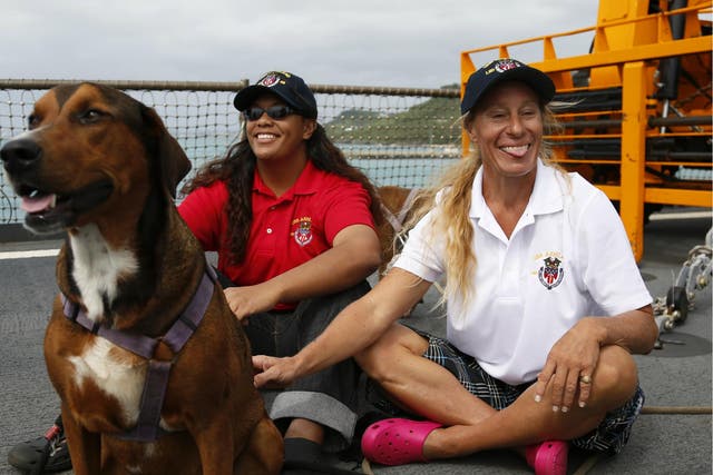 Jennifer Appel, right, and Tasha Fuiava sit with their dogs on the deck of the USS Ashland Monday, 30 October 2017 in Okinawa, Japan.