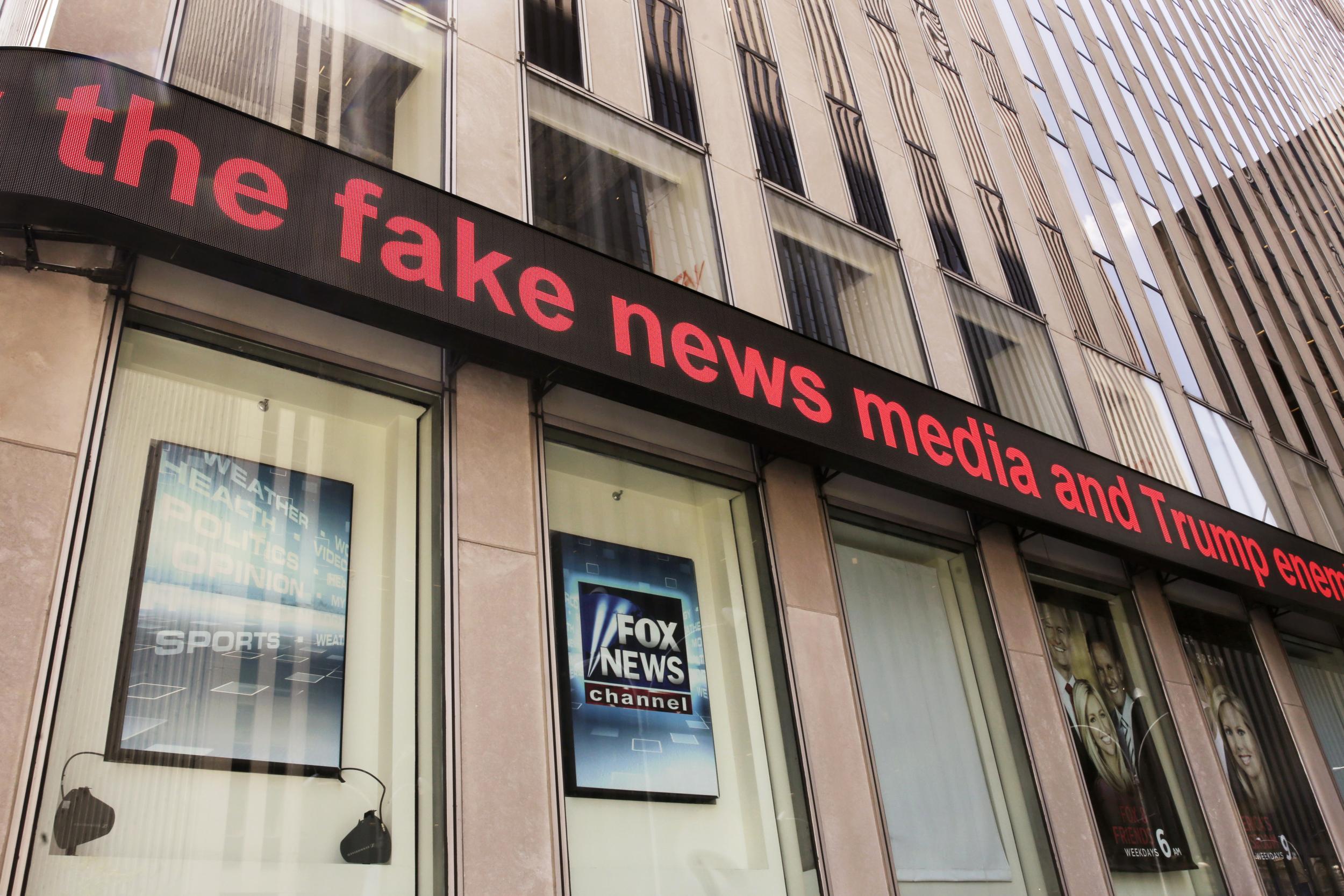 News headlines scroll above the Fox News studios in the News Corporation headquarters building in New York