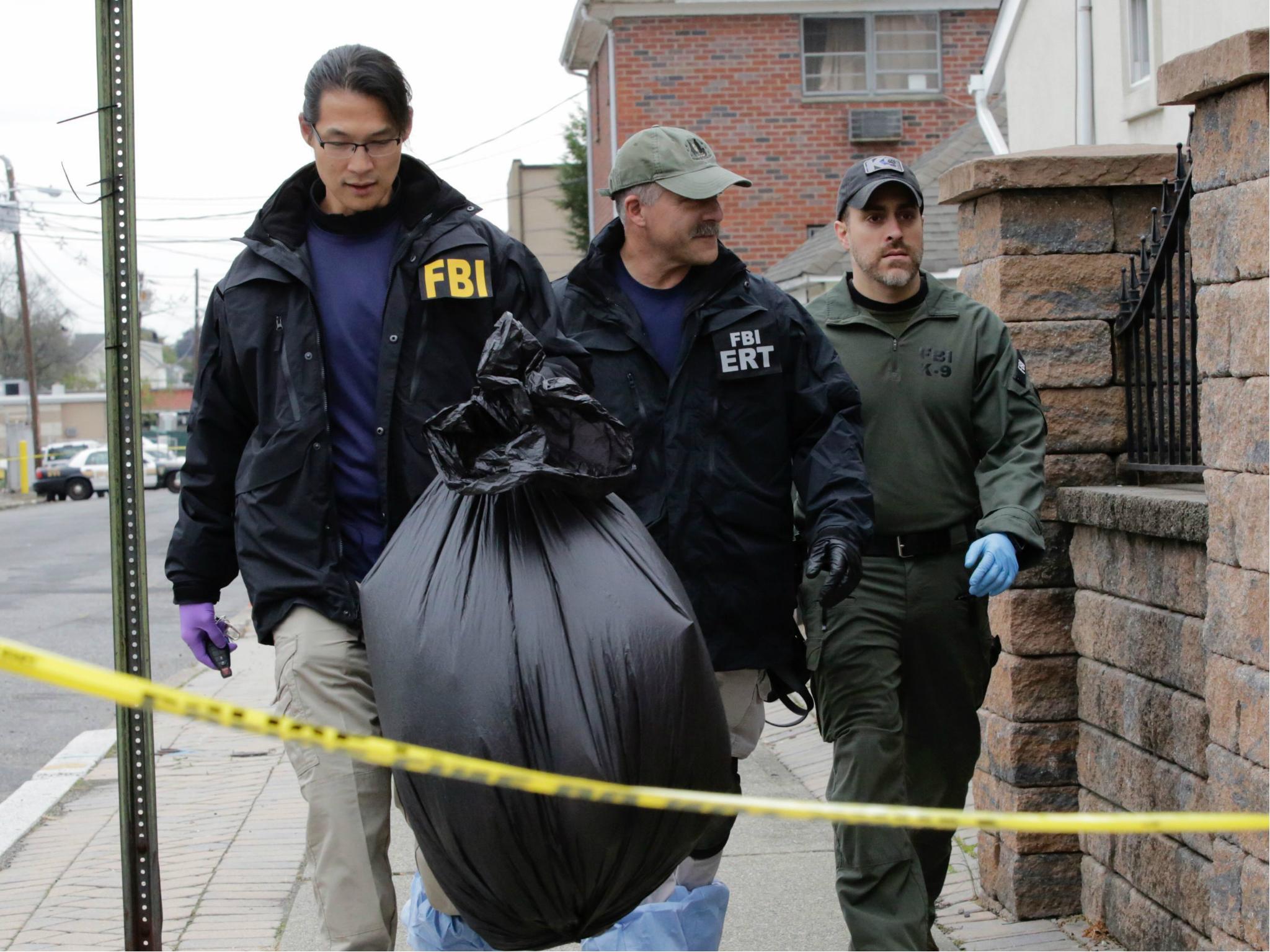 FBI officers walk outside of suspect terrorist Sayfullah Saipovs apartment, on 1 November 2017, in Paterson, New Jersey.