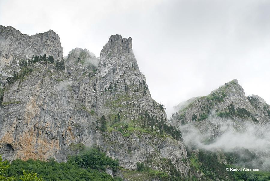 Crags wreathed in low cloud line the Ropojana valley, Montenegro