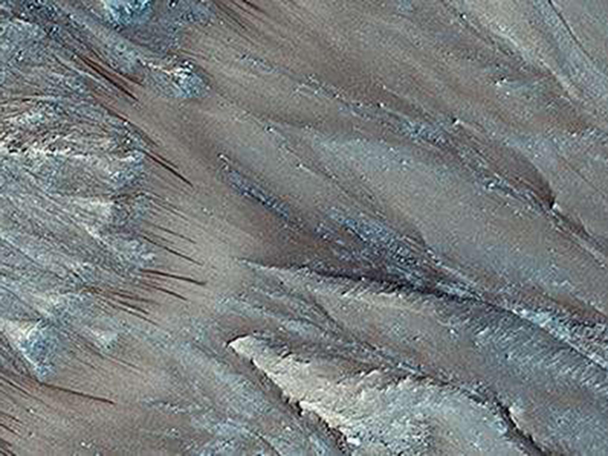 Dark streaks on the planet’s surface appear once a year (Nasa/JPL/University of Arizona)