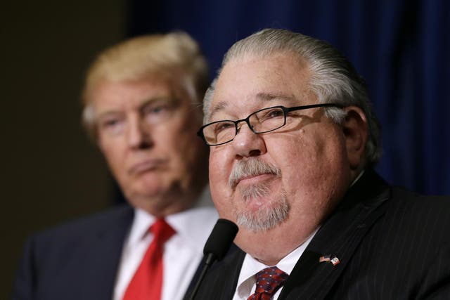 Sam Clovis speaks during a news conference as then-Republican presidential candidate Donald Trump watches