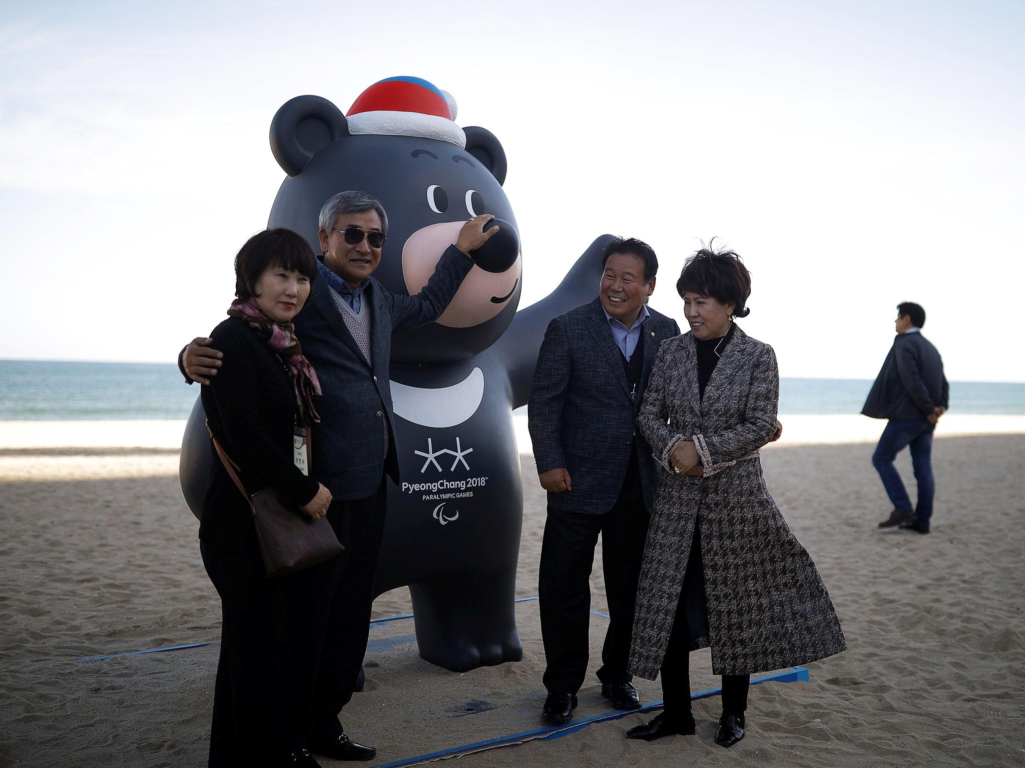 People pose with 2018 PyeongChang Winter Paralympics mascot Bandabi at the beach in the east coast city of Gangneung (Reuters)