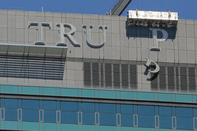 Workers remove letters from the "TRUMP" sign on top of the Trump International Hotel and Tower, after the project's new owner reached a deal with Trump Hotels to buy out its management contracts, in downtown Toronto, Canada on July 18, 2017