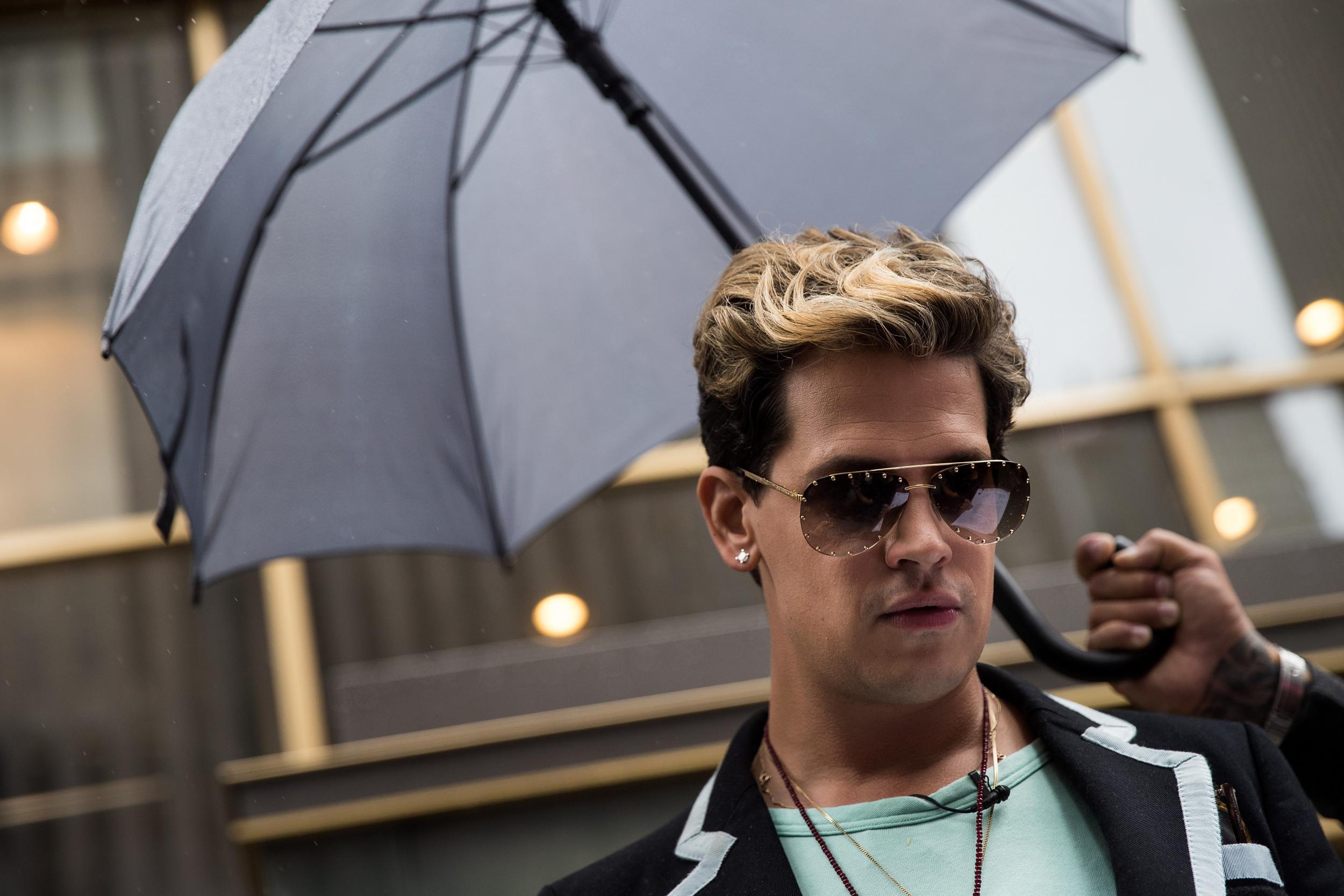 Milo Yiannopoulos pauses while speaking outside the offices of Simon & Schuster publishing company