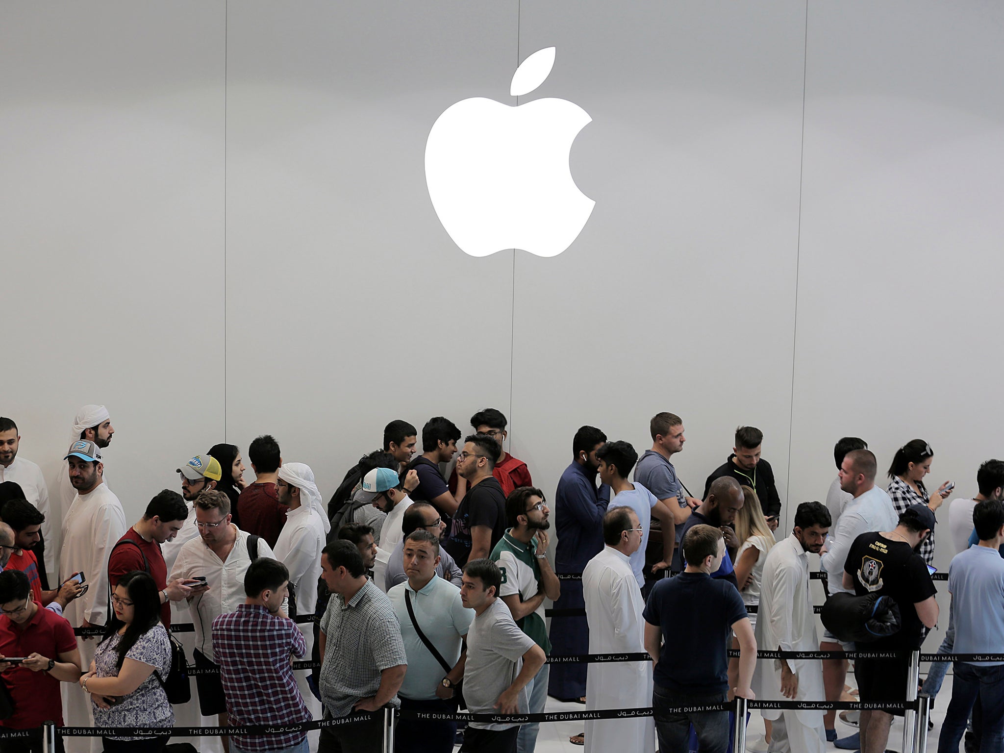 Customers queue for the latest release of Apple's iPhone