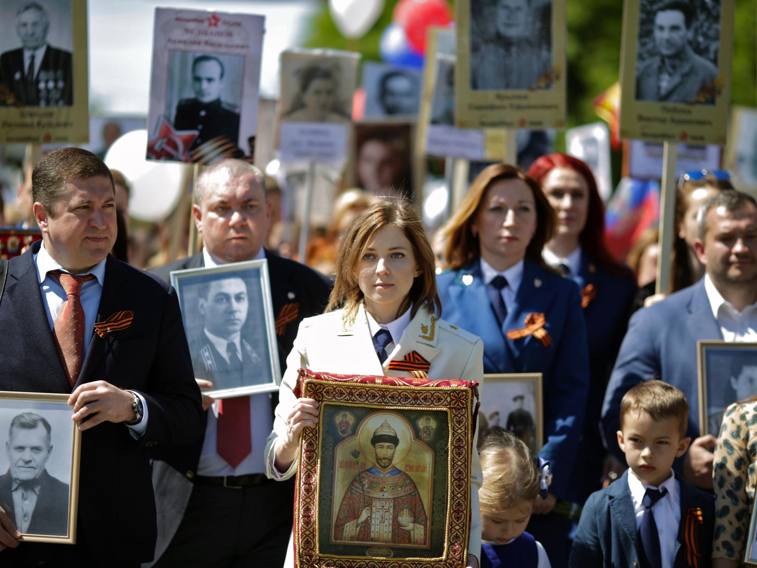 Crimea’s chief prosecutor Natalia Poklonskaya carries a portrait of the last Russian tsar Nicholas II on Victory Day celebrations in Simferopol last year