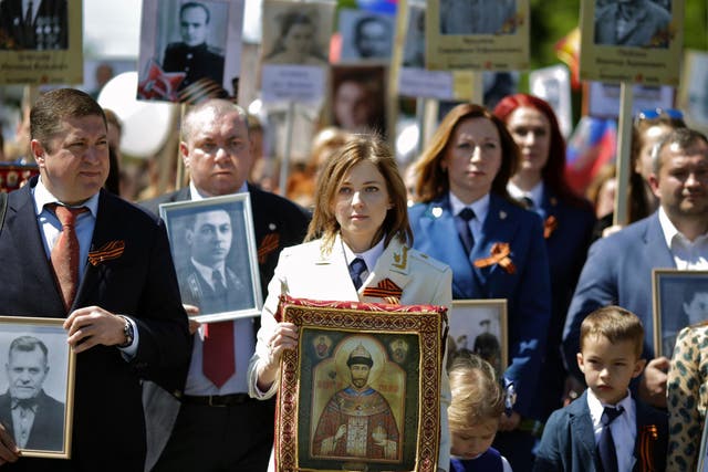 Crimea’s chief prosecutor Natalia Poklonskaya carries a portrait of the last Russian tsar Nicholas II on Victory Day celebrations in Simferopol last year
