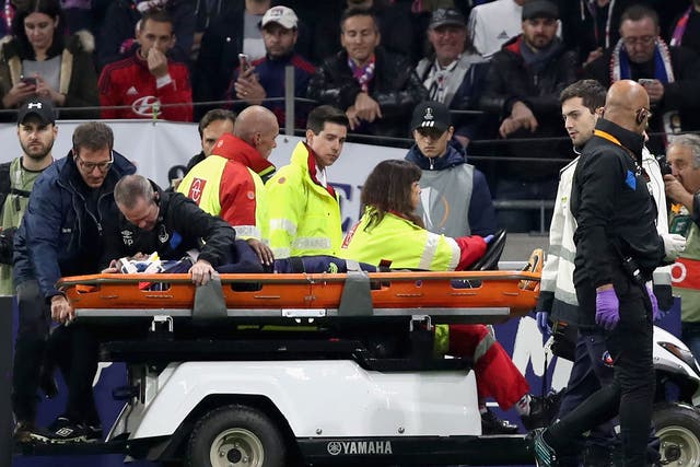Cuco Martina is stretchered off after suffering a heavy fall against Lyon last night