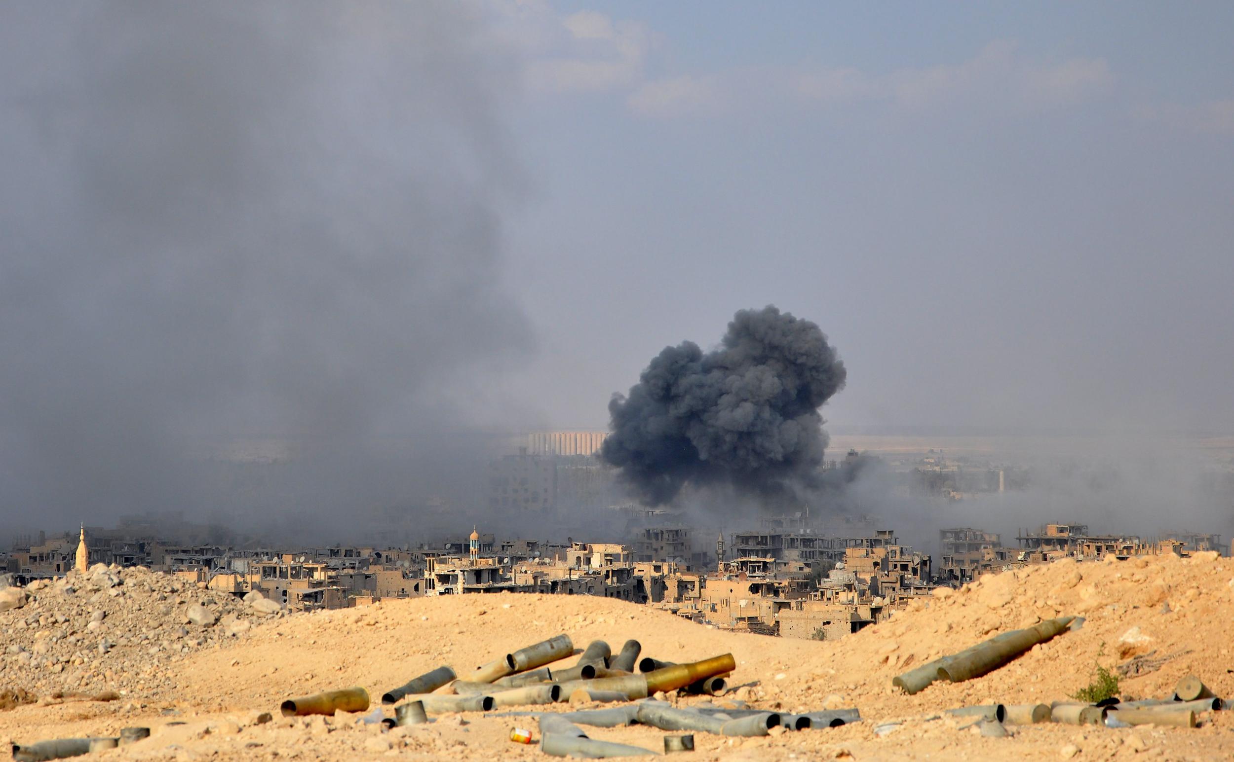 Smoke billows from Deir Ezzor during fighting between Syrian government forces and Isis (AFP/Getty)