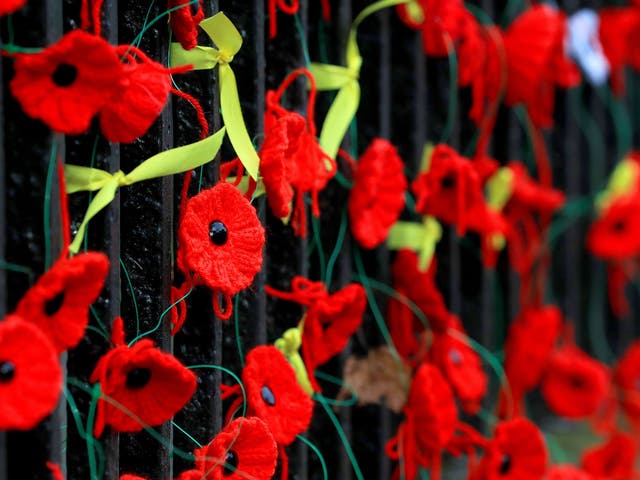 Knitted poppies and yellow ribbons placed outside Holy Trinity Church in Wavertree, Liverpool