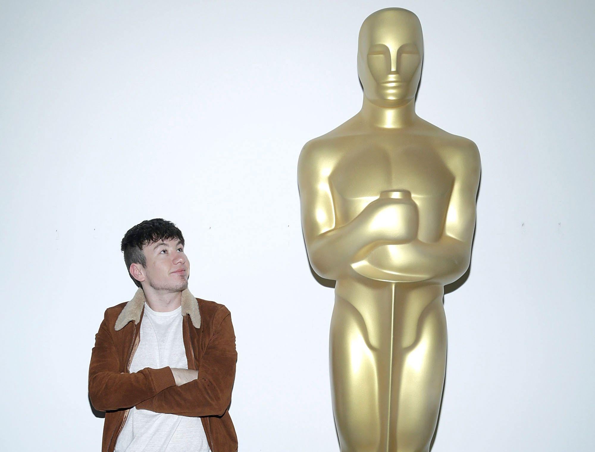 Barry Keoghan alongside a large Oscar statuette