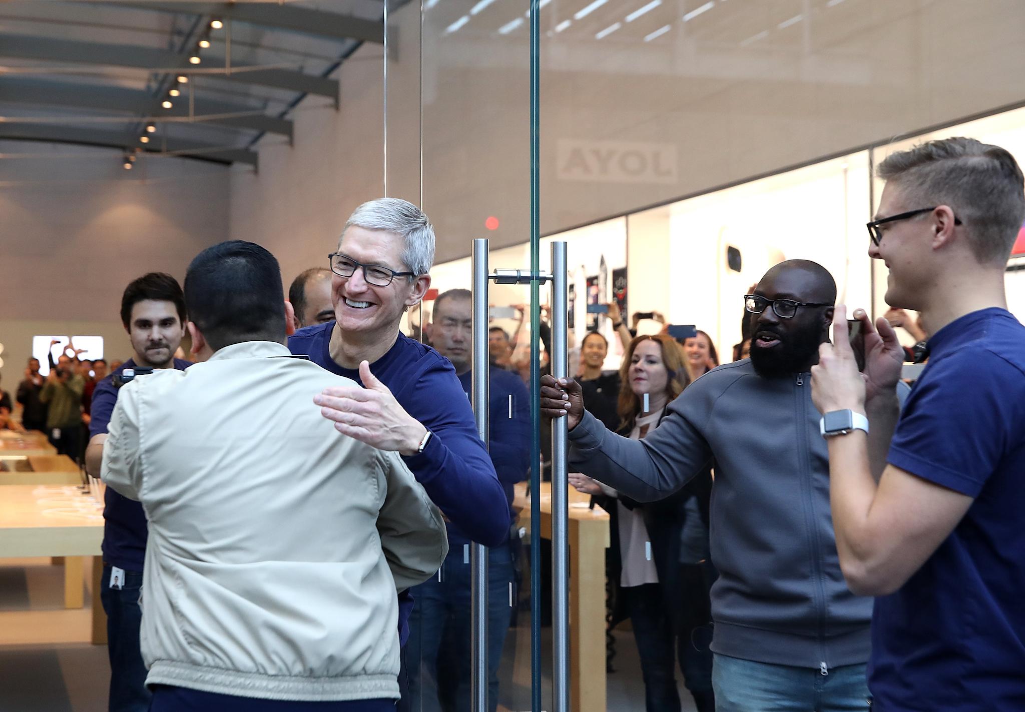 CEO Tim Cook greets customers as they prepare to purchase a new iPhone X in Palo Alto, California