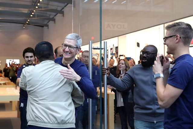 CEO Tim Cook greets customers as they prepare to purchase a new iPhone X in Palo Alto, California