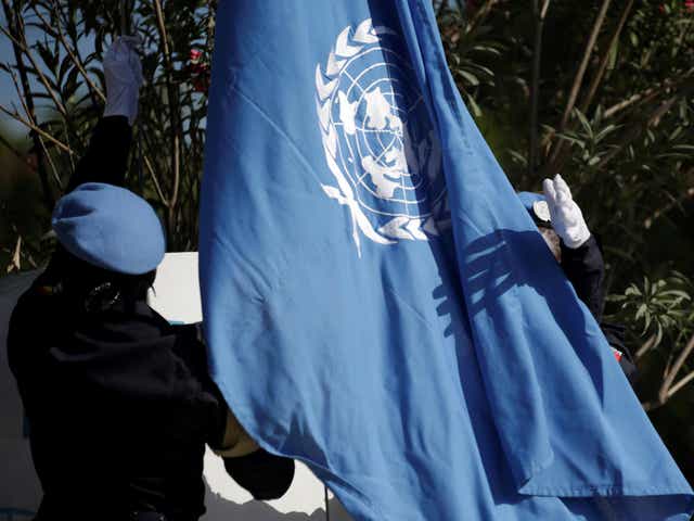 Senegalese officers raise a United Nations flag during the opening ceremony of the Mission for Justice support in Haiti
