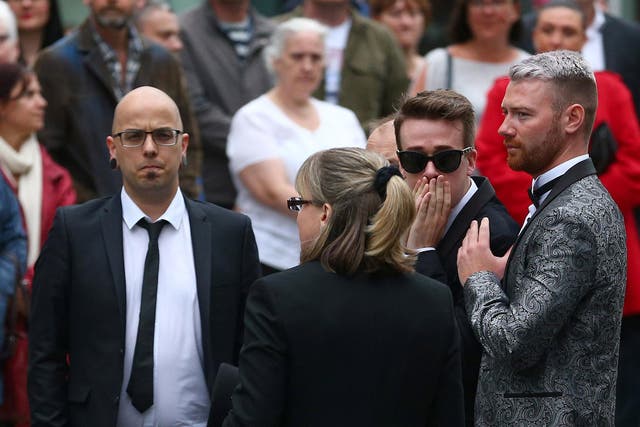 Dan Hett (left) with Martyn's partner Russell Hayward (2nd right) at his funeral at Stockport Town Hall in June
