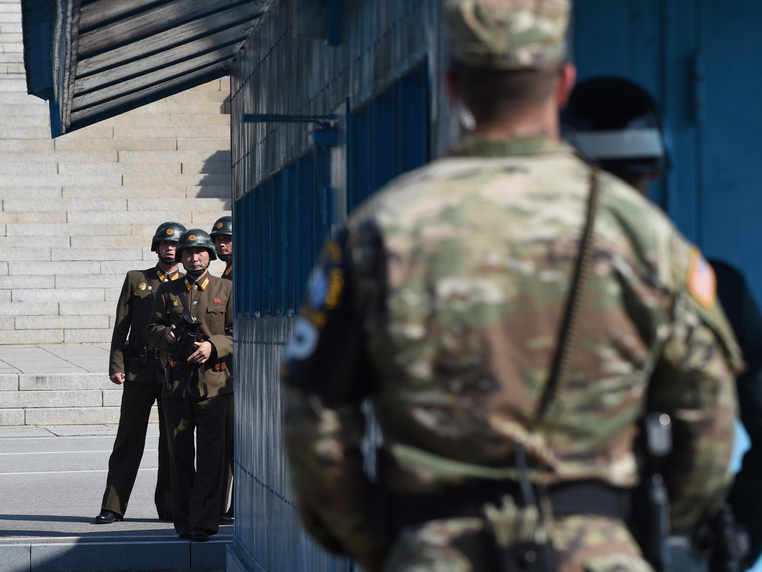 North Korean soldiers look at the South side while US Secretary of Defence Jim Mattis and South Korean Defence Minister Song Young-Moo visit at the truce village of Panmunjom in the Demilitarized Zone on the border between North and South Korea on 27 October 2017