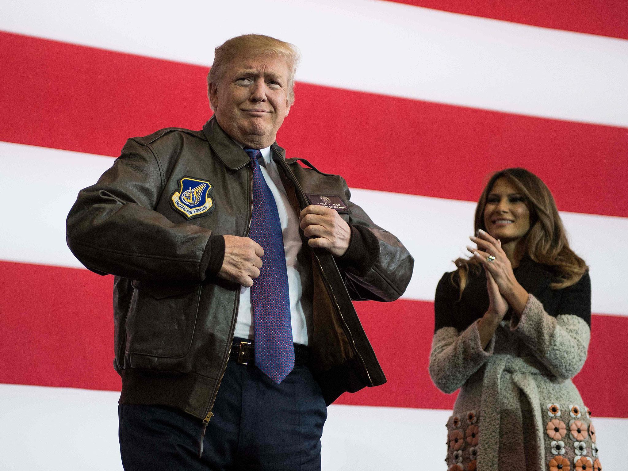 Donald Trump (R) prepares to address US soldiers as his wife Melania looks on upon arriving at US Yokota Air Base in Tokyo