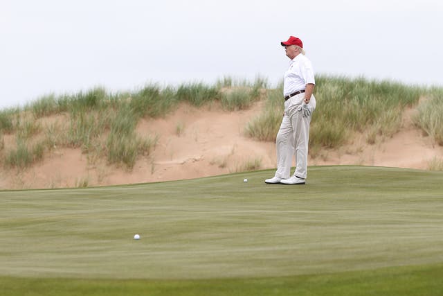 Donald Trump playing at his golf course at its grand opening in 2012