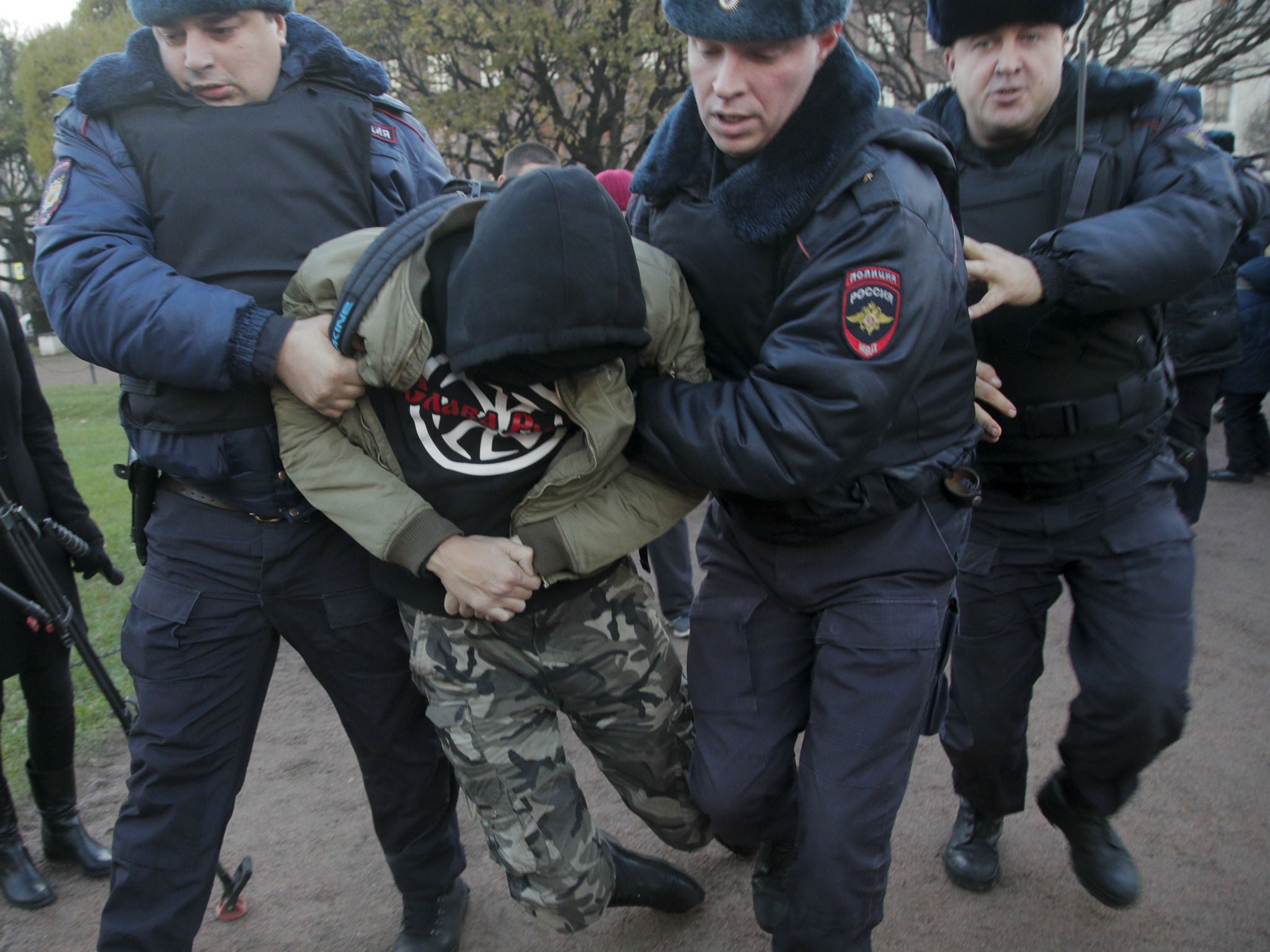 Police detain a man during a protest in St Petersburg on Sunday