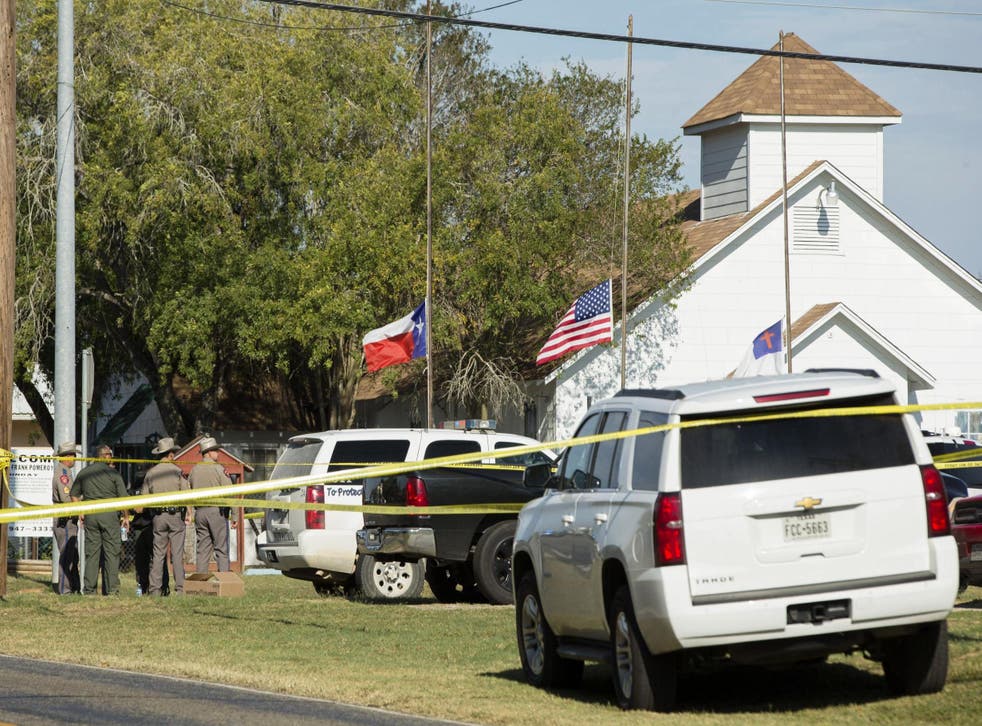 Law enforcement officials gather near the First Baptist Church in Sutherland Springs