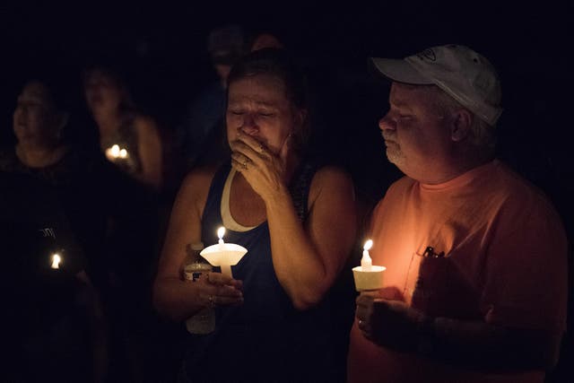 Mourners at a candlelight vigil for the victims of the shooting at the First Baptist Church
