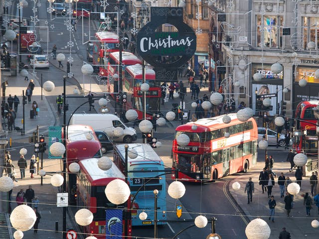 Buses driving around Oxford Street