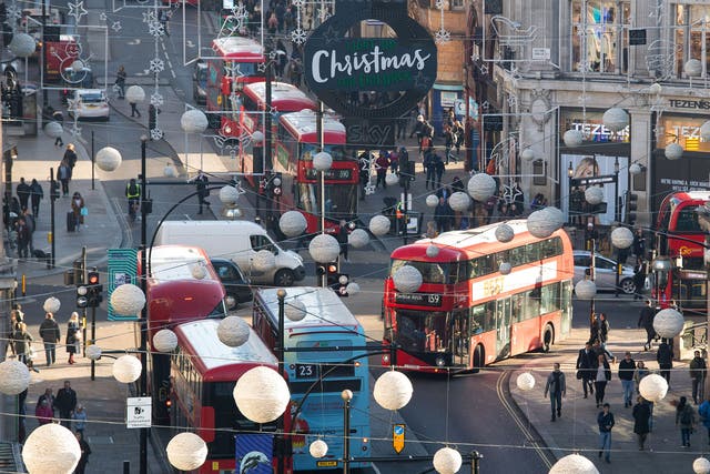 Buses driving around Oxford Street