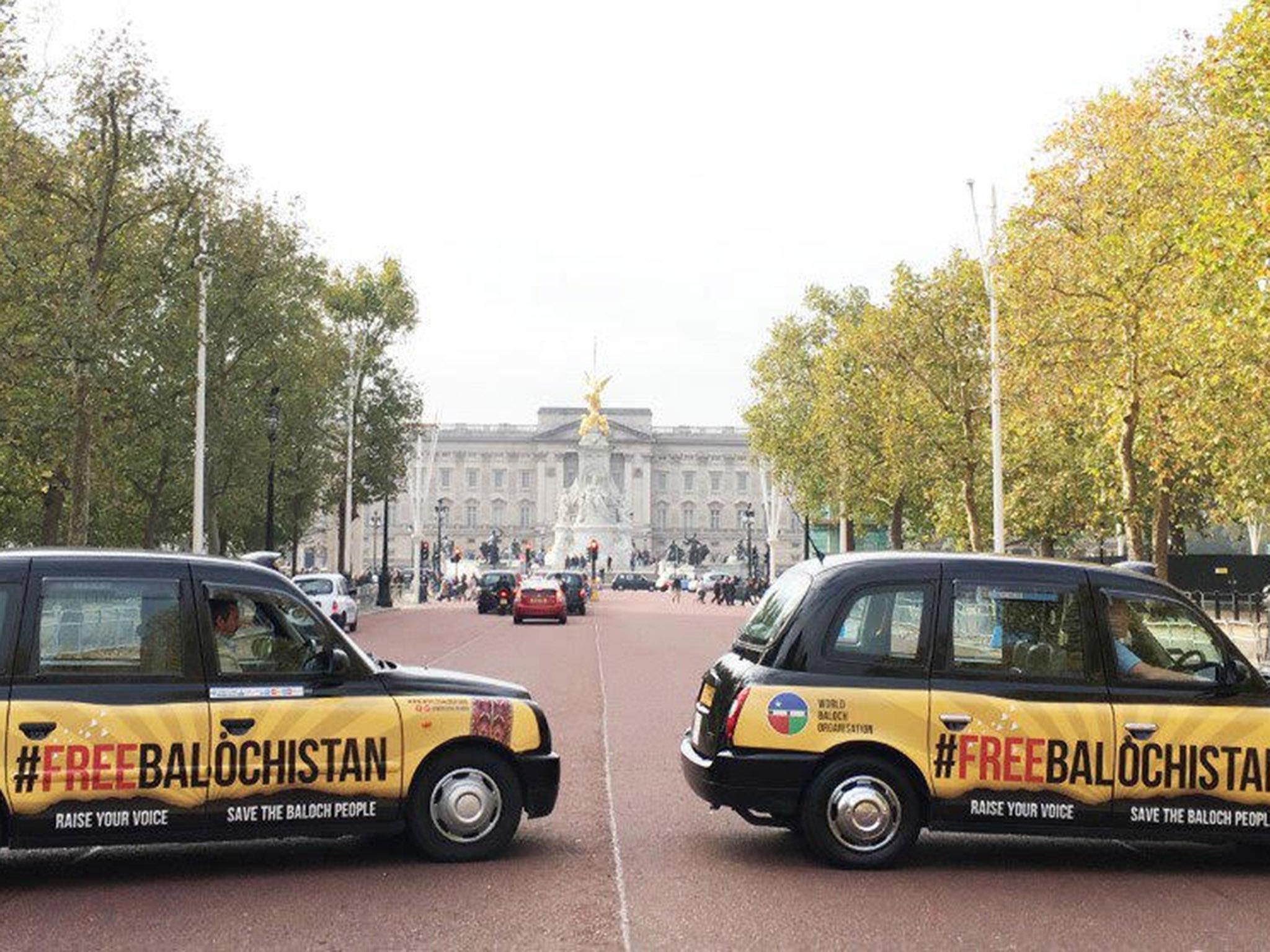 Black cabs with the poster on them outside Buckingham Palace in west London on 6 November