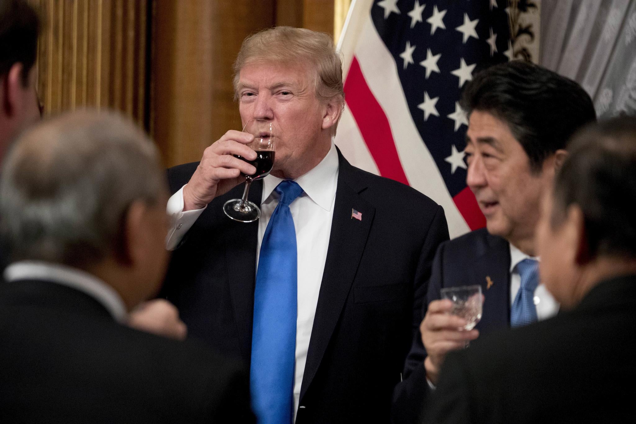 US President Donald Trump and Japanese Prime Minister Shinzo Abe, right, share a drink after toasting each other during a state banquet at the Akasaka Palace (AP Photo/Andrew Harnik)
